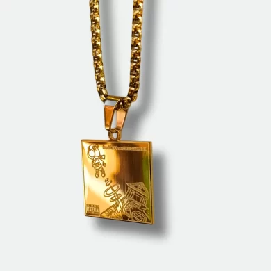 Front view of gold pendant featuring Kanye West's "Graduation" album cover and back view with engraved tracklist