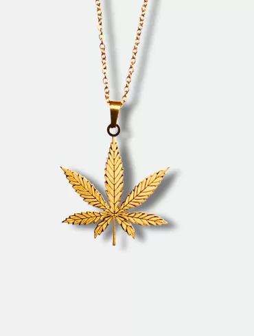 Gold pendant featuring a detailed cannabis leaf design