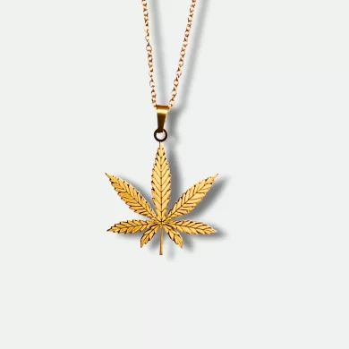 Gold pendant featuring a detailed cannabis leaf design