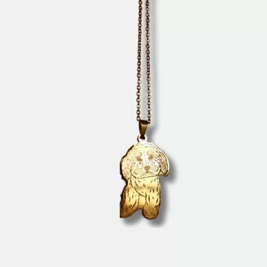 Gold pendant with a hand-drawn illustration of a dog and custom engraving