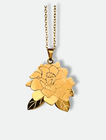 Gold pendant with a hand-drawn illustration of a flower and custom engraving