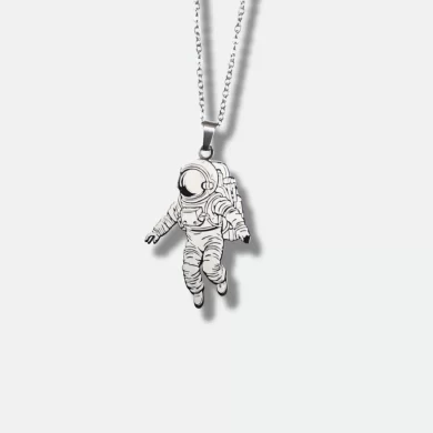 Silver pendant with a detailed astronaut design and engraved inspirational quote